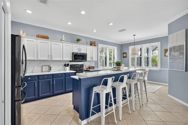 a kitchen with stainless steel appliances granite countertop a sink counter space cabinets and a large window