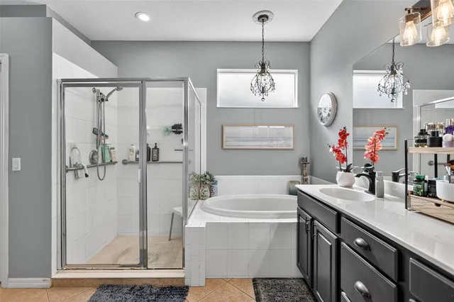 a bathroom with a tub sink and mirror