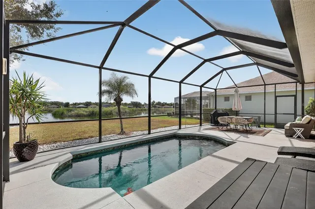 a patio with glass top table and chairs