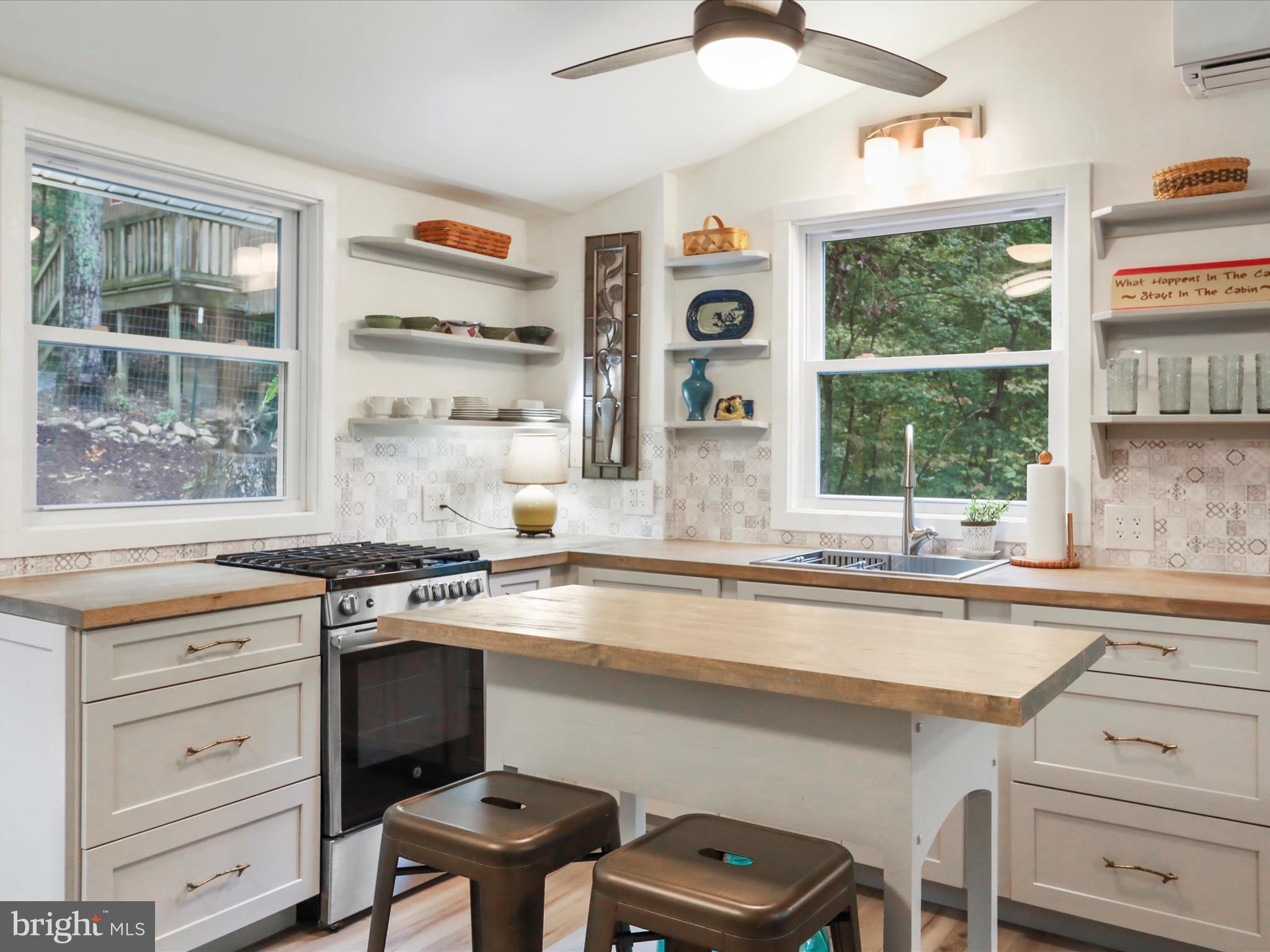 570 Cedar Road Strasburg, VA 22657 - Photo 7 of 47 a kitchen with a stove a sink and a window