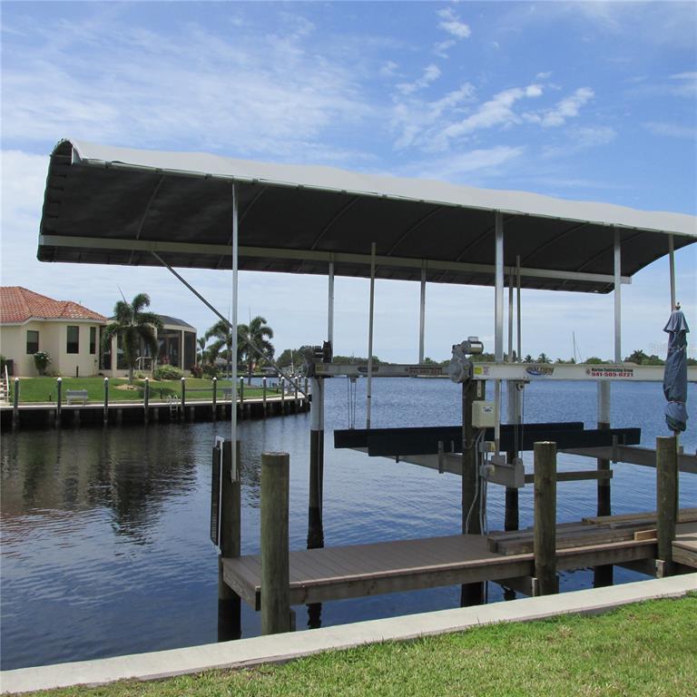 142 Beeney Road Southeast Port Charlotte, FL 33952 - Photo 1 of 1 Boat Lift and cover w/view of the water