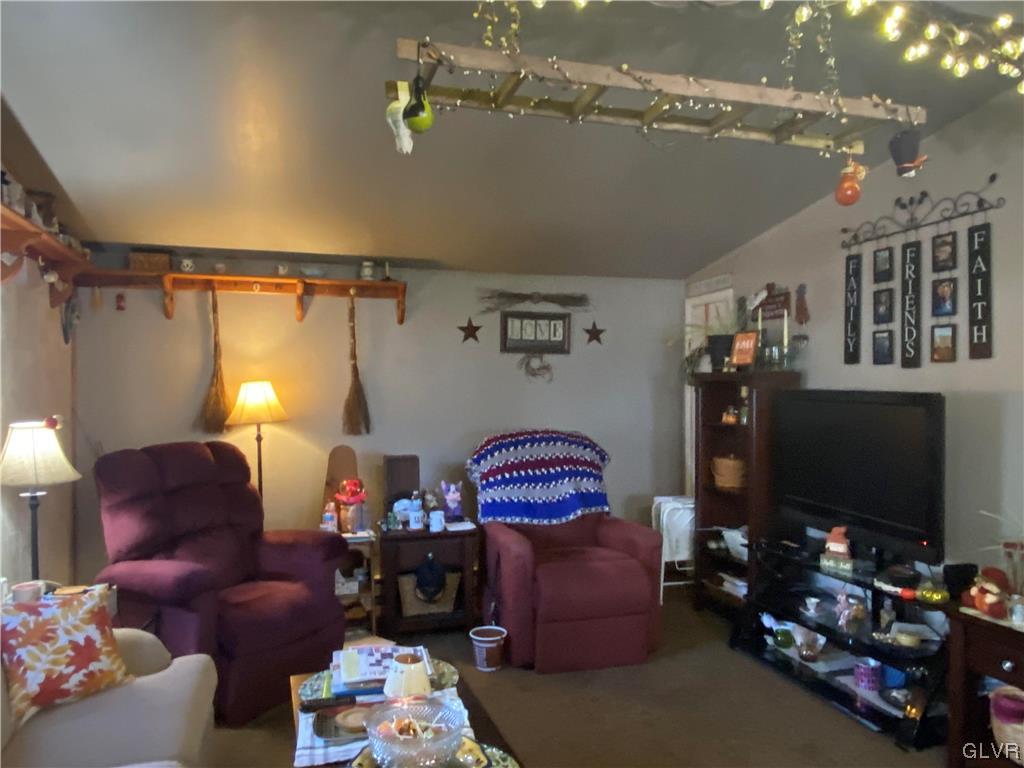 118 East Ruddle Street Coaldale, PA 18218 - Photo 14 of 42 a living room with furniture a flat screen tv and a chandelier