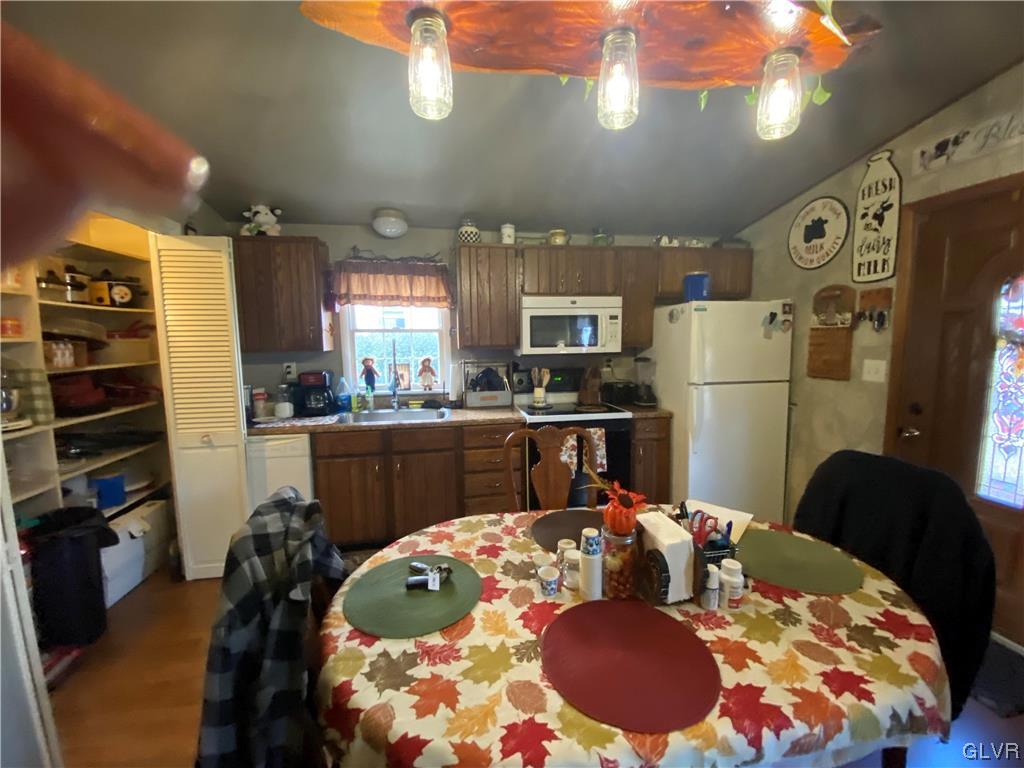 118 East Ruddle Street Coaldale, PA 18218 - Photo 17 of 42 a kitchen with stainless steel appliances kitchen island granite countertop a refrigerator a stove a microwave oven with a dining table and chairs