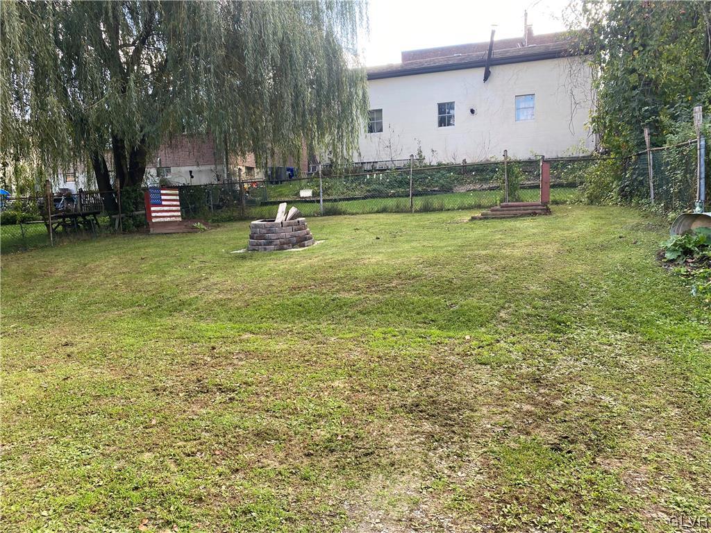 118 East Ruddle Street Coaldale, PA 18218 - Photo 42 of 42 a backyard of a house with lots of green space and fountain
