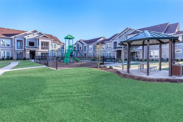 a living room with dining room and kitchen view