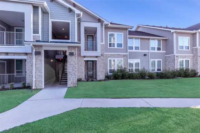 a view of a yard in front of a brick building