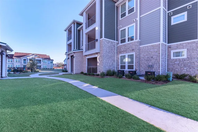 a view of a building with a yard