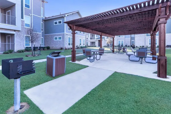 a view of a backyard with plants and a patio