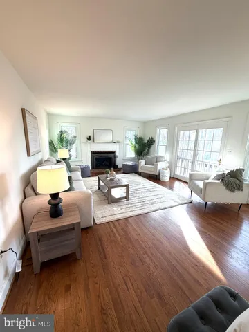 a living room with furniture a fireplace and a potted plant