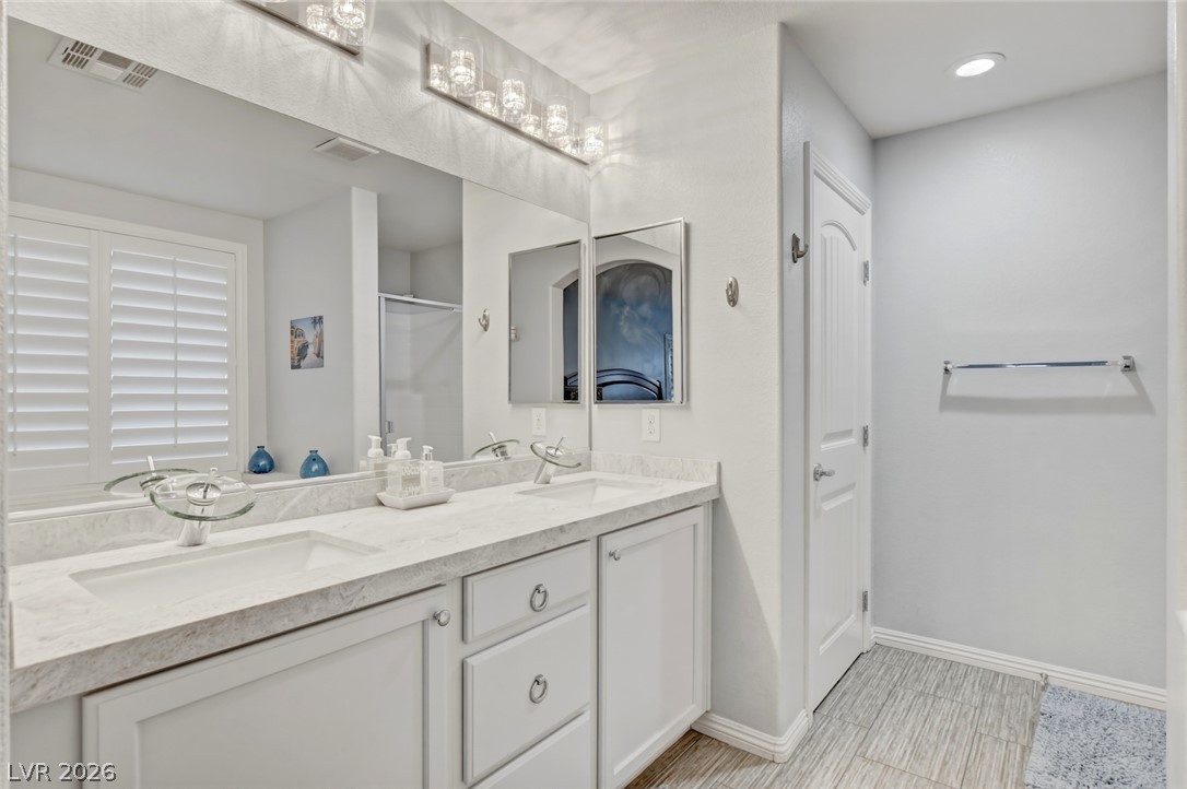 48 Jasmine Point Street Henderson, NV 89074 - Photo 41 of 62 A well-appointed bath features a double vanity and recessed lighting.