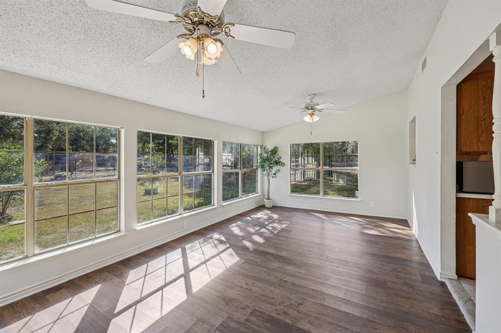 a view of room with window and wooden floor