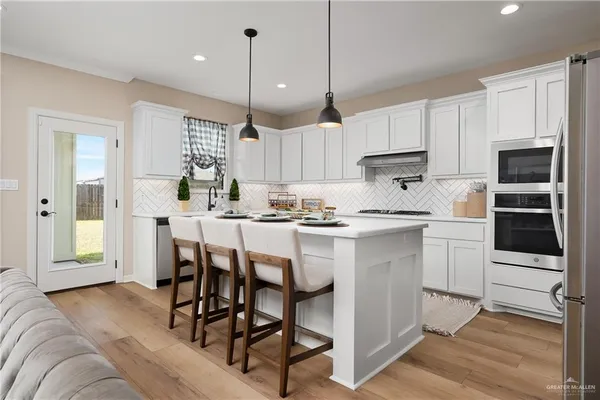 a kitchen with a table chairs refrigerator and cabinets