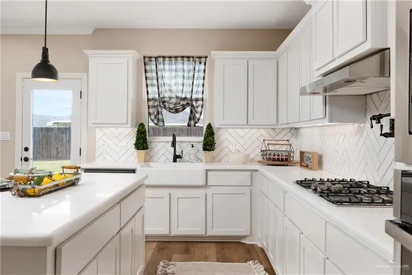 a kitchen with sink and cabinets