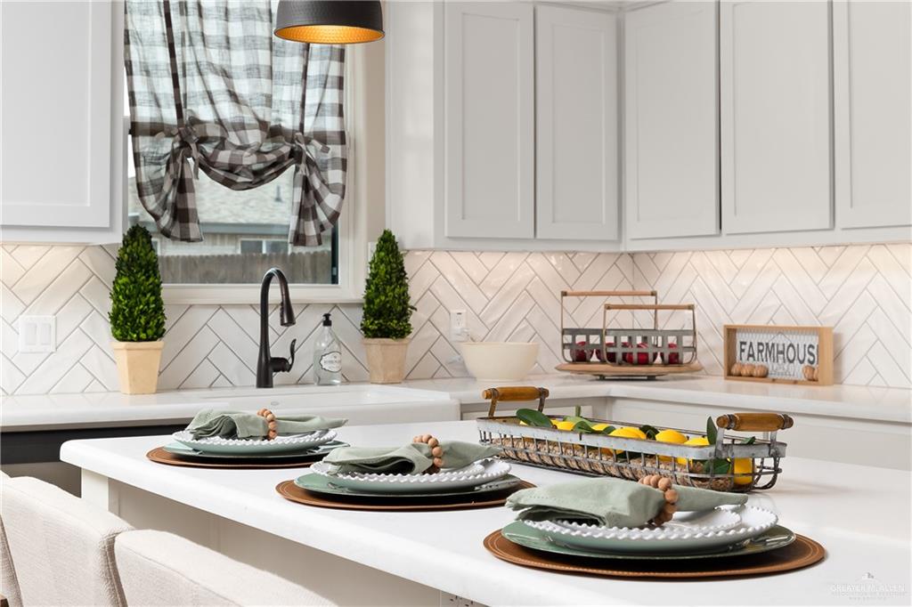 6343 Cascada Bnd Road McAllen, TX 78504 - Photo 16 of 35 a table with a vase and white flowers