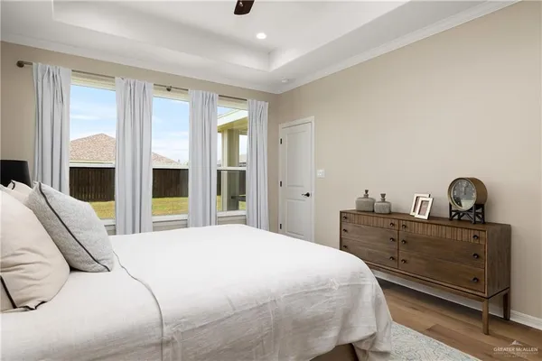 a bedroom with a bed and a large window