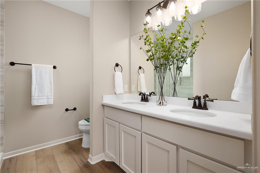 6343 Cascada Bnd Road McAllen, TX 78504 - Photo 23 of 35 a bathroom with a sink a toilet and a mirror