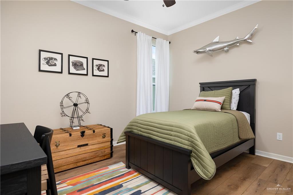 6343 Cascada Bnd Road McAllen, TX 78504 - Photo 24 of 35 a bed sitting in a bedroom next to a window