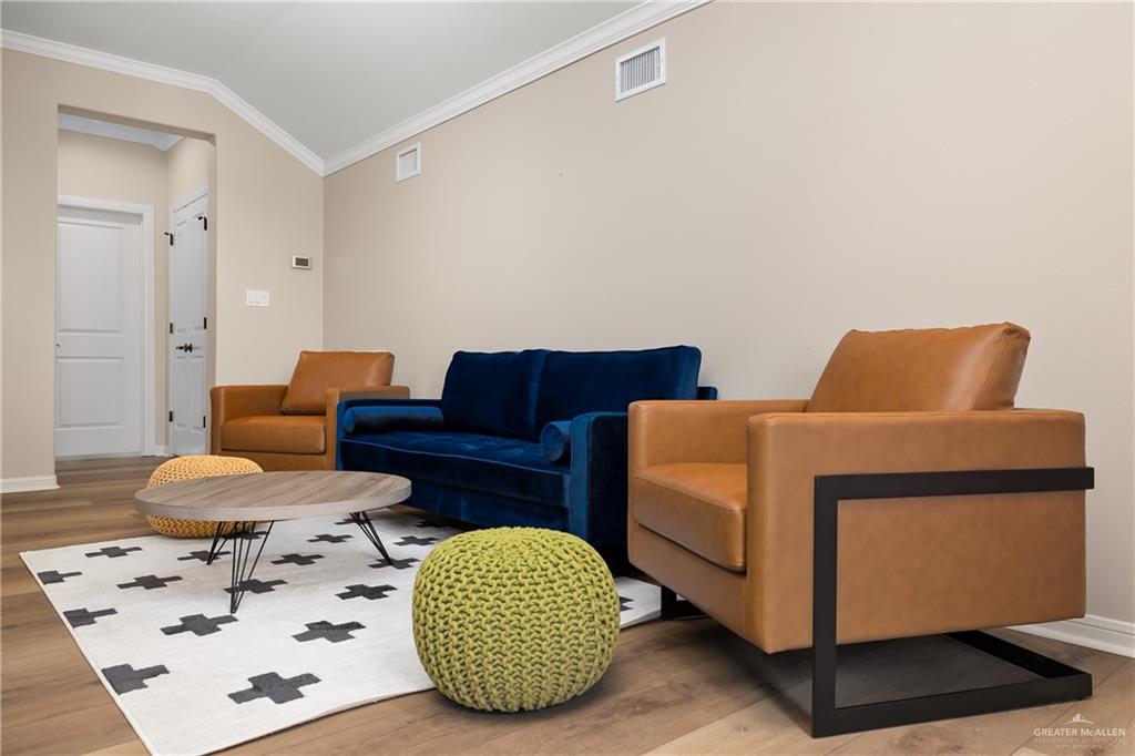 6343 Cascada Bnd Road McAllen, TX 78504 - Photo 27 of 35 a bedroom with a bed and wooden floor