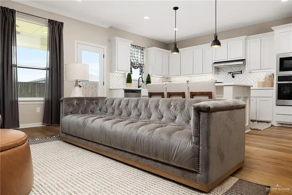 a living room with stainless steel appliances kitchen island granite countertop furniture and a view of kitchen