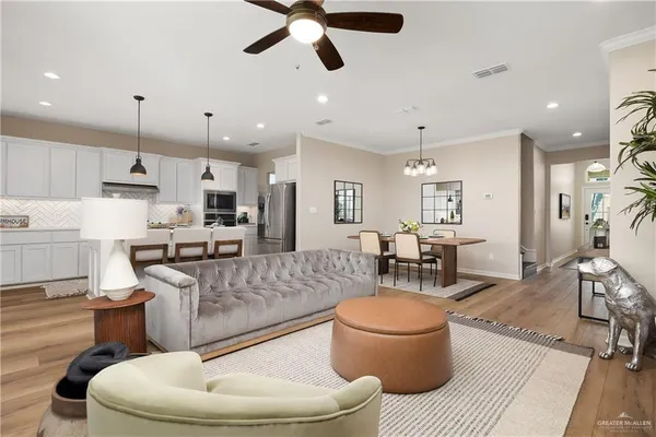 a living room with furniture and kitchen view