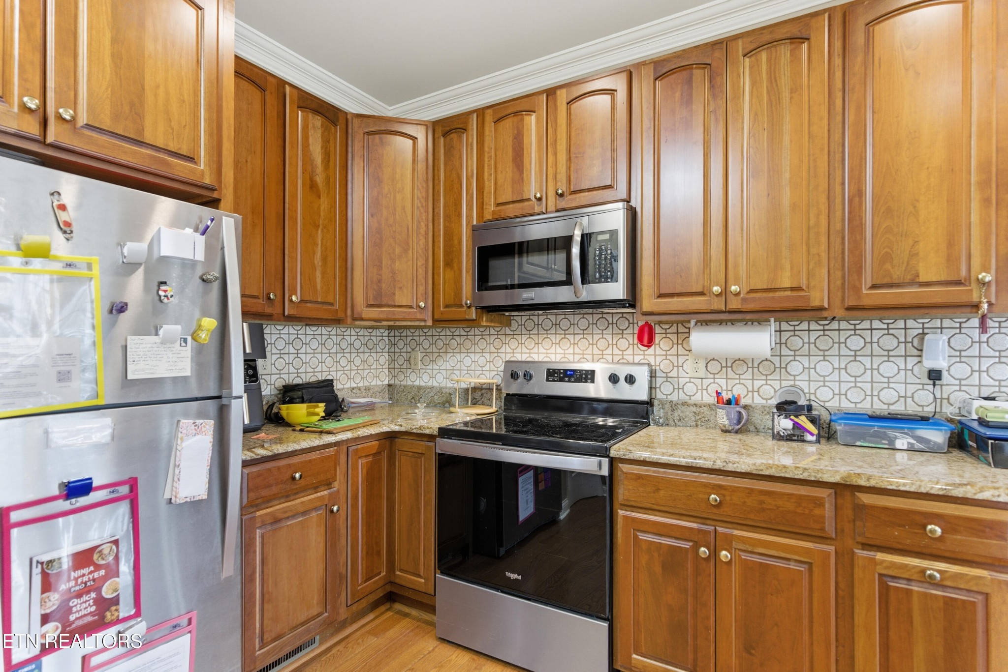 92 North Claymore Lane Oak Ridge, TN 37830 - Photo 8 of 32 a kitchen with stainless steel appliances granite countertop a refrigerator sink and microwave