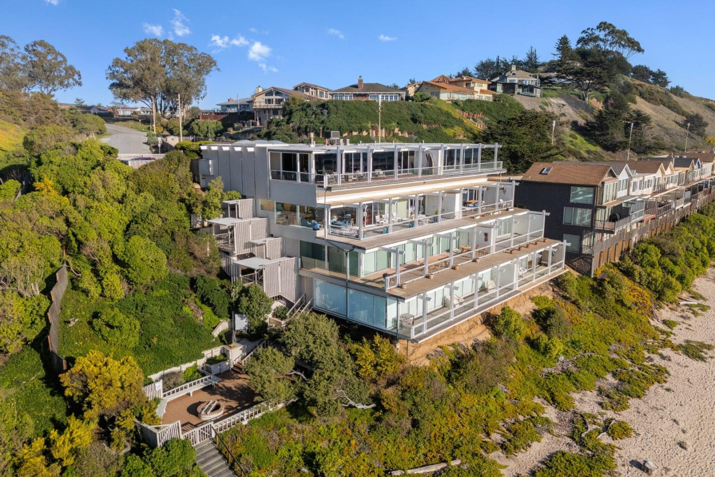 an aerial view of a house with a big yard and large trees