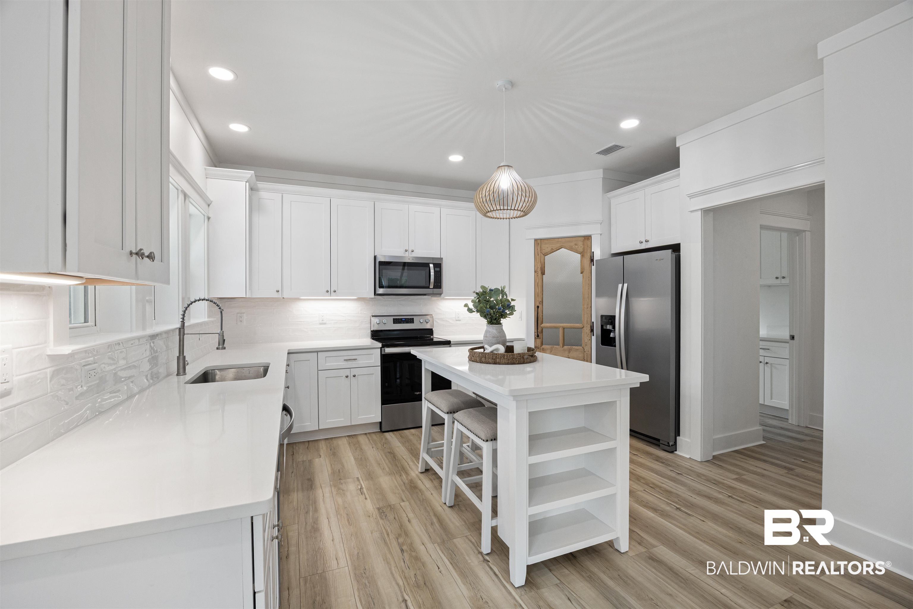 27591 Canal Road Orange Beach, AL 36561 - Photo 11 of 51 Kitchen with open shelves, a kitchen island, white cabinets, decorative backsplash, and recessed lighting