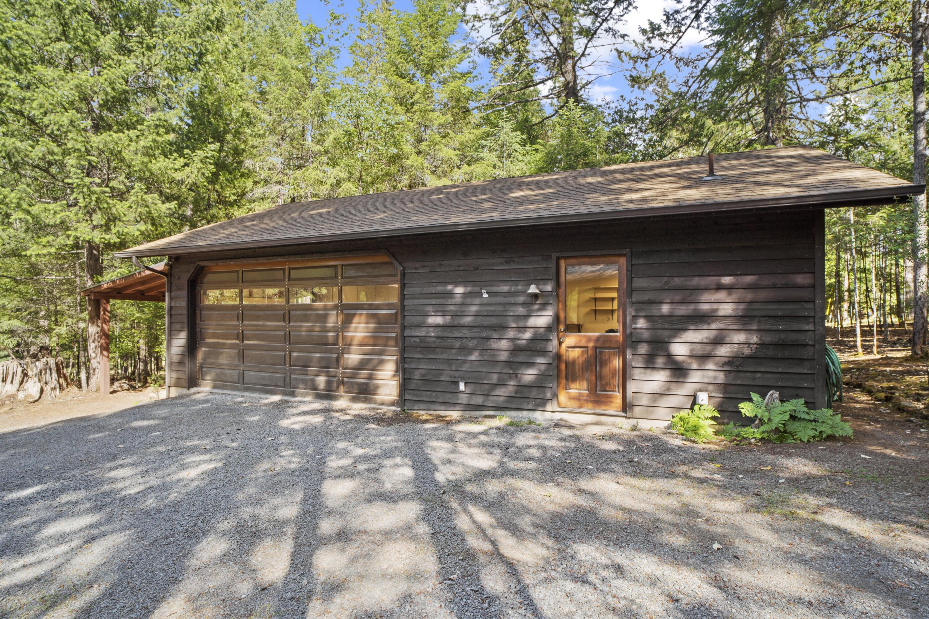 2021 Queens Branch Road Rogue River, OR 97537 - Photo 26 of 37 a front view of a house with a garden