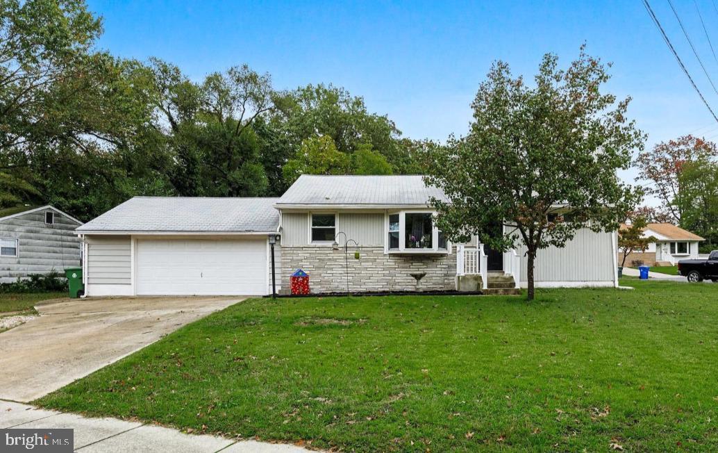 202 Rule Court Glassboro, NJ 08028 - Photo 2 of 26 a front view of a house with a garden and trees