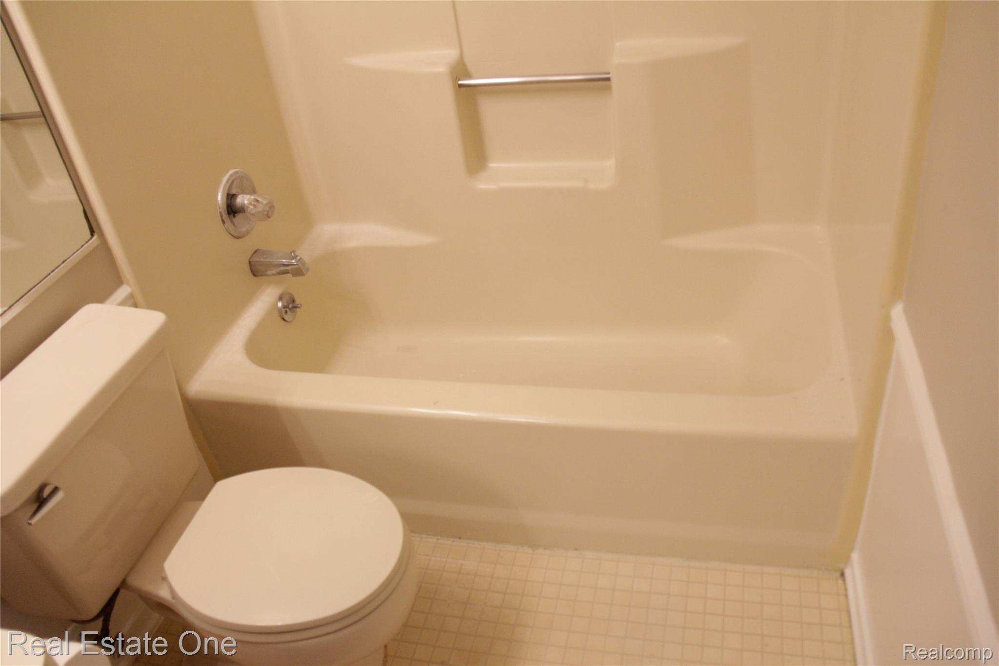 44777 Saltz Road Canton, MI 48187 - Photo 46 of 65 Bathroom featuring a white toilet, integrated bathtub and shower unit, chrome fixtures, and square tile flooring