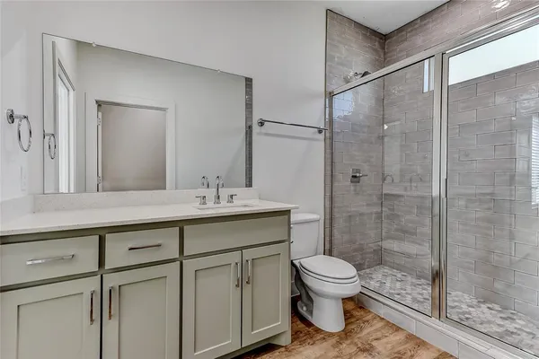 a bathroom with a toilet a sink and a shower