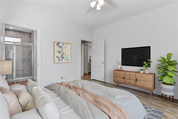 a bedroom with a bed and a flat screen tv