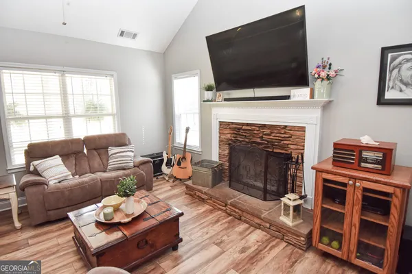 a living room with furniture fireplace and flat screen tv