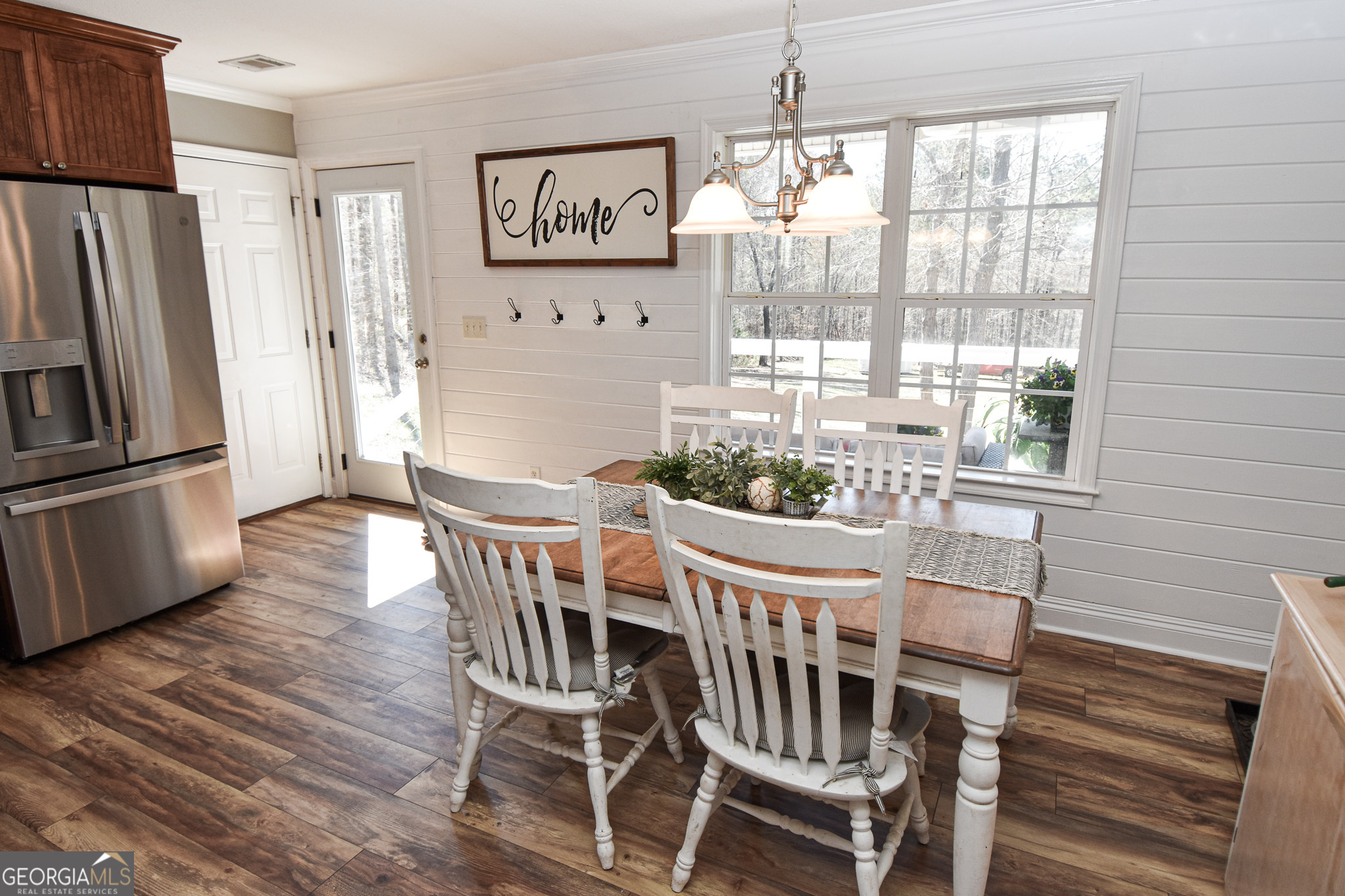 1515 Smyrna Church Road Molena, GA 30258 - Photo 13 of 34 a dining room with furniture a chandelier and wooden floor