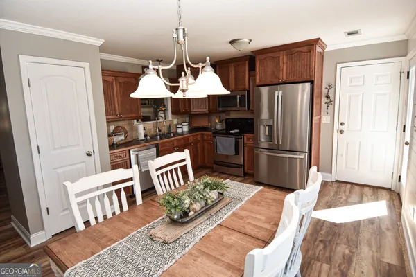 a kitchen with granite countertop a refrigerator and a stove top oven