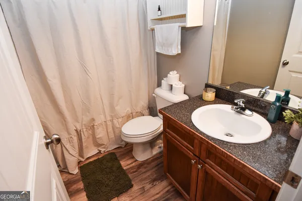 a bathroom with a sink a toilet and a mirror