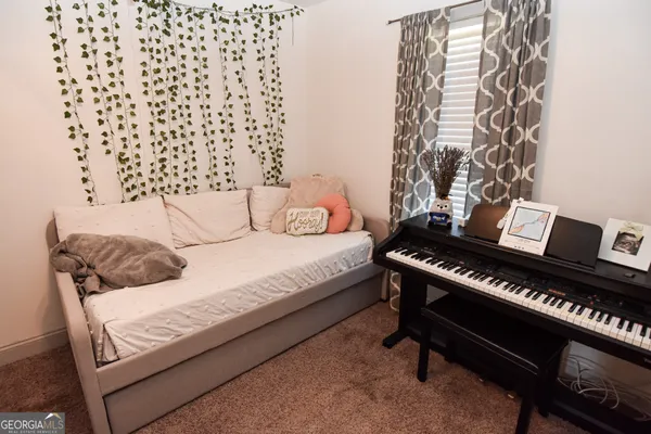 a bedroom with a bed and a piano