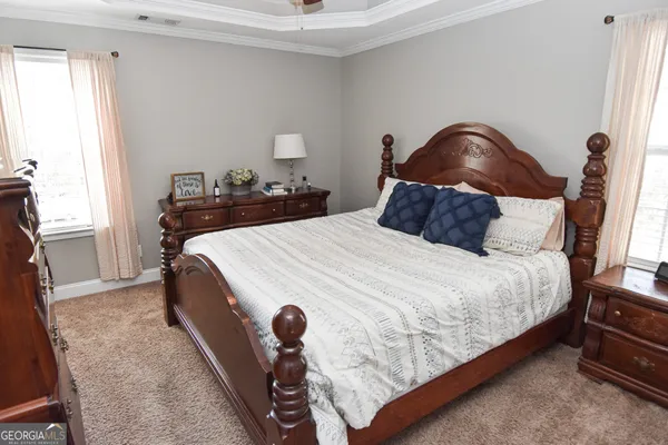 a bedroom with bed and window