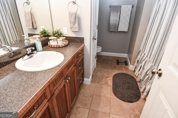 a bathroom with a sink a mirror and vanity