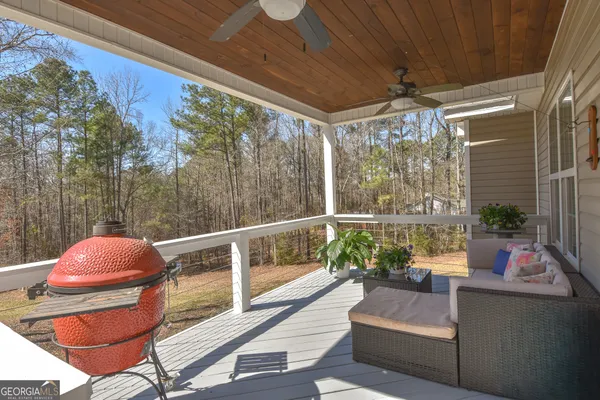 a balcony with furniture and a potted plant