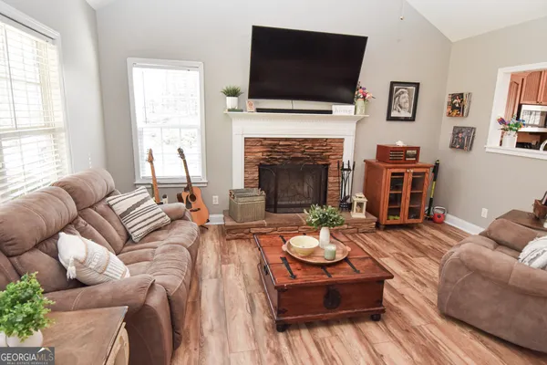 a living room with furniture fireplace and flat screen tv