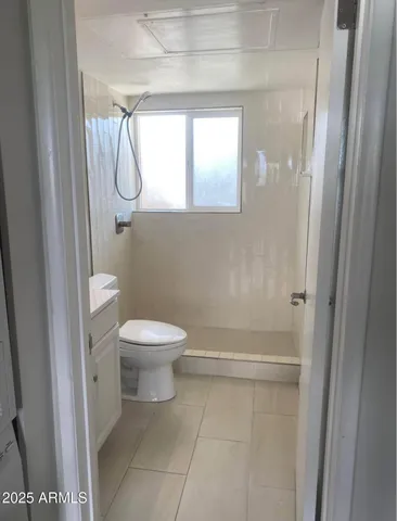 a bathroom with a granite countertop toilet a sink and a shower