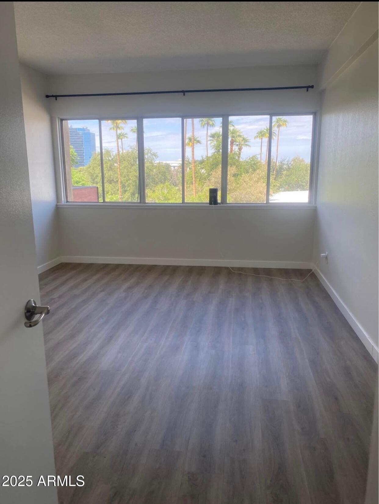 353 East Thomas Road, Unit C404 Phoenix, AZ 85004 - Photo 6 of 18 a view of an empty room with a window