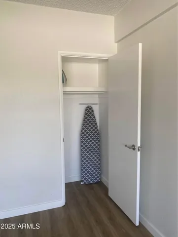 a view of a room with wooden floor and white walls