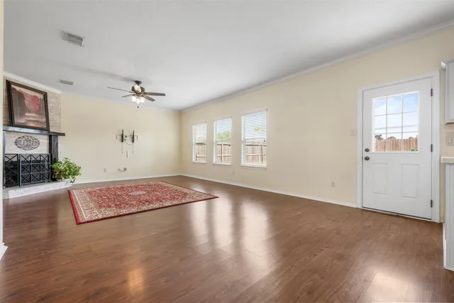a furnished livingroom with a ceiling fan and a window