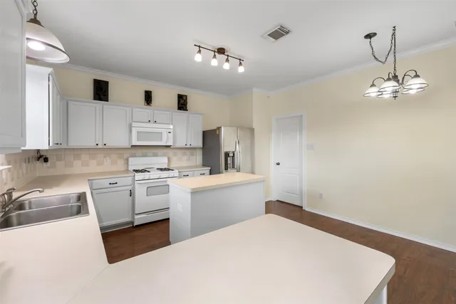 a front view of house with yard and trees in the background