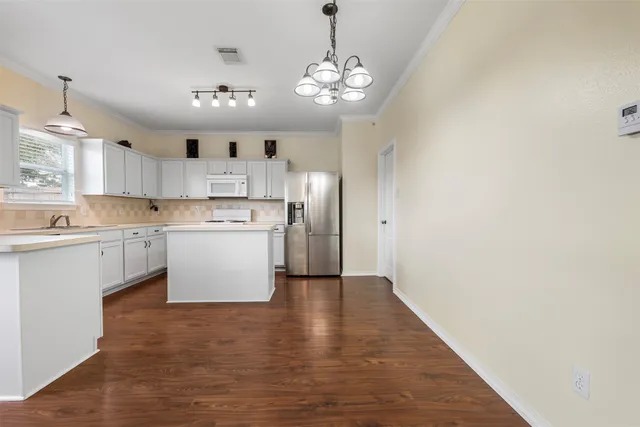 a view of a backyard with table and chairs and wooden fence