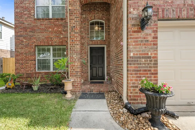 a view of a room with wooden floor and large windows