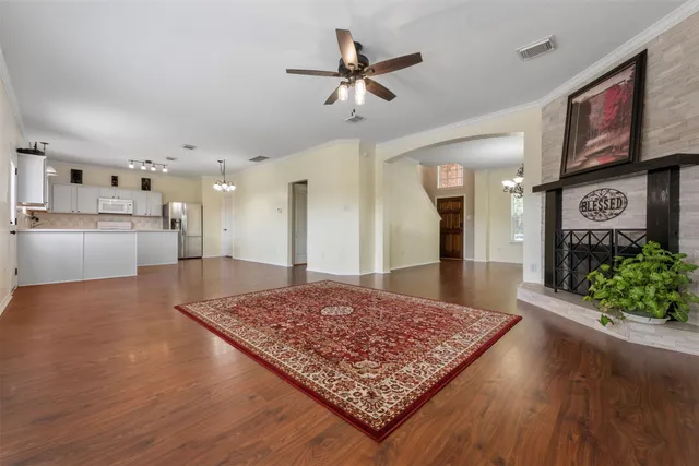 an empty room with a ceiling fan and a window