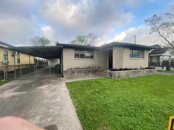 a front view of house with yard and outdoor seating